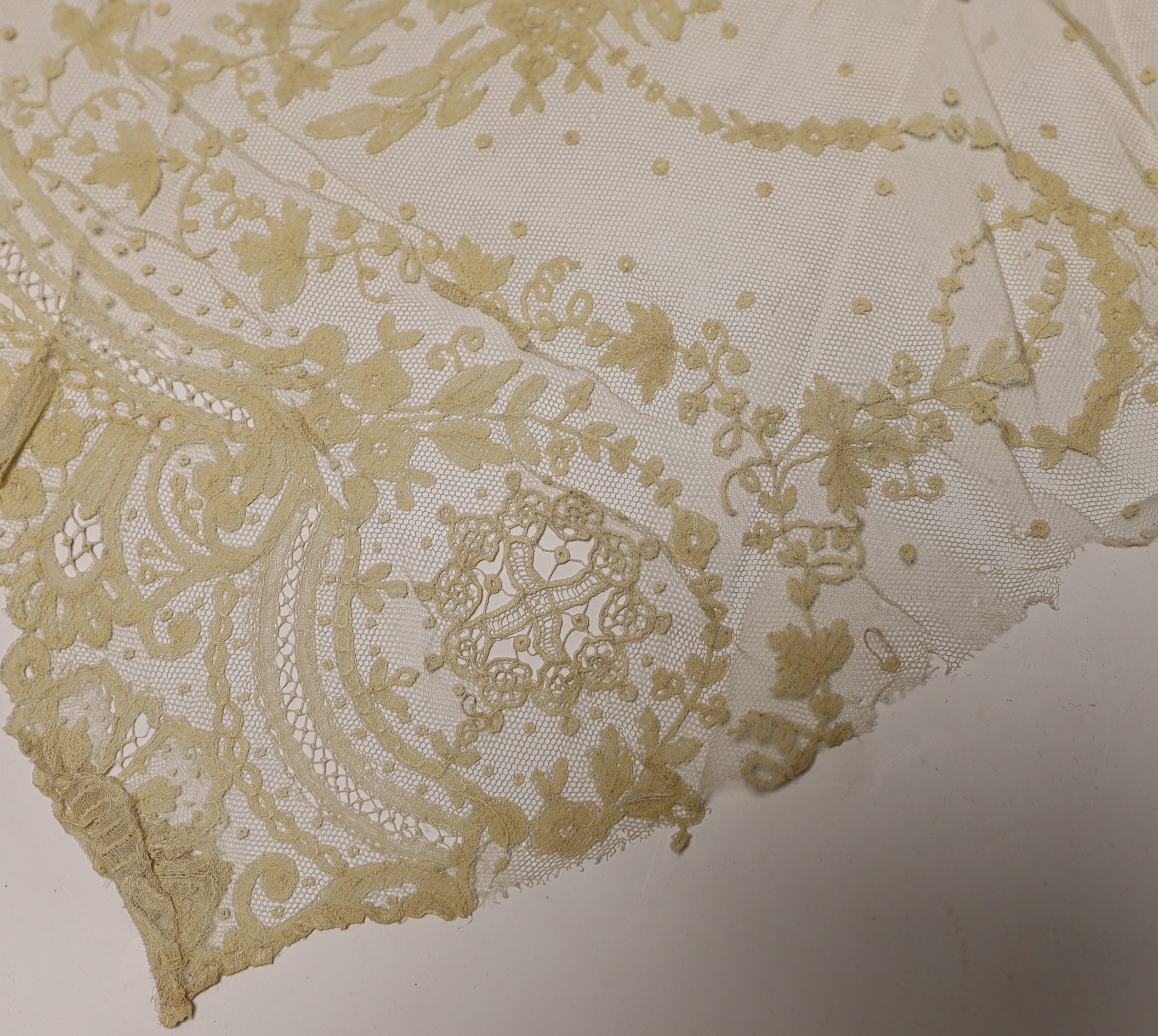 Late 19th century bobbin lace trimming: a length of mixed Brussels bobbin and needle lace trim, 255cm x 30cm and another length in the same design 126cm x 30cm together with a Honiton bobbin lace length 460cm x 50cm and
